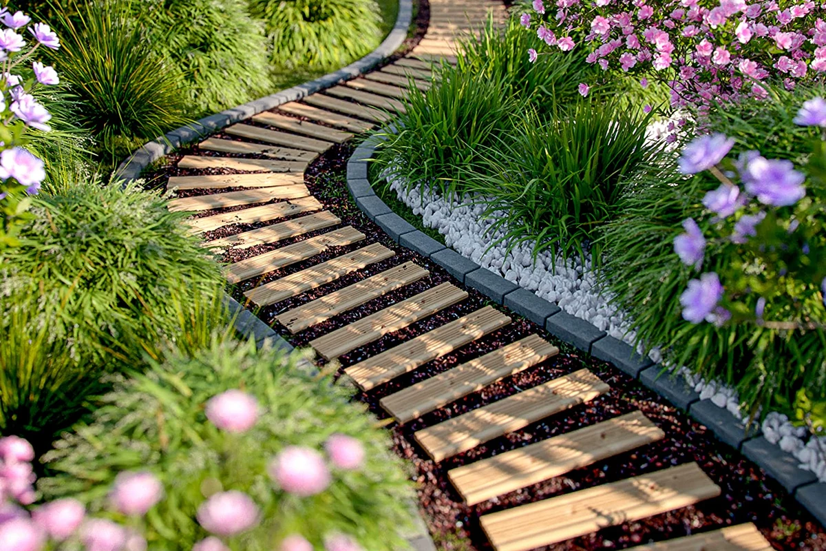 Natural garden path surrounded by greenery and flowers